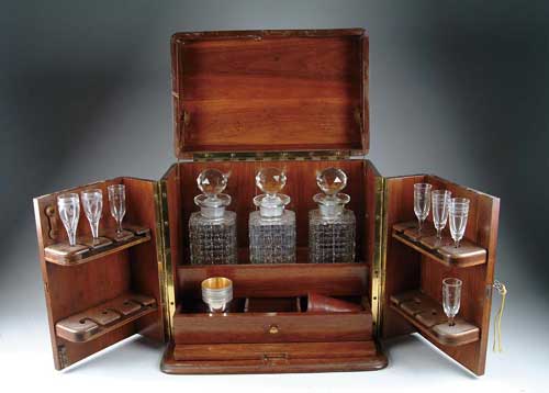 Appraisal: MAHOGANY LIQUEUR TANTALUS The traveling liqueur cabinet has hinged lid