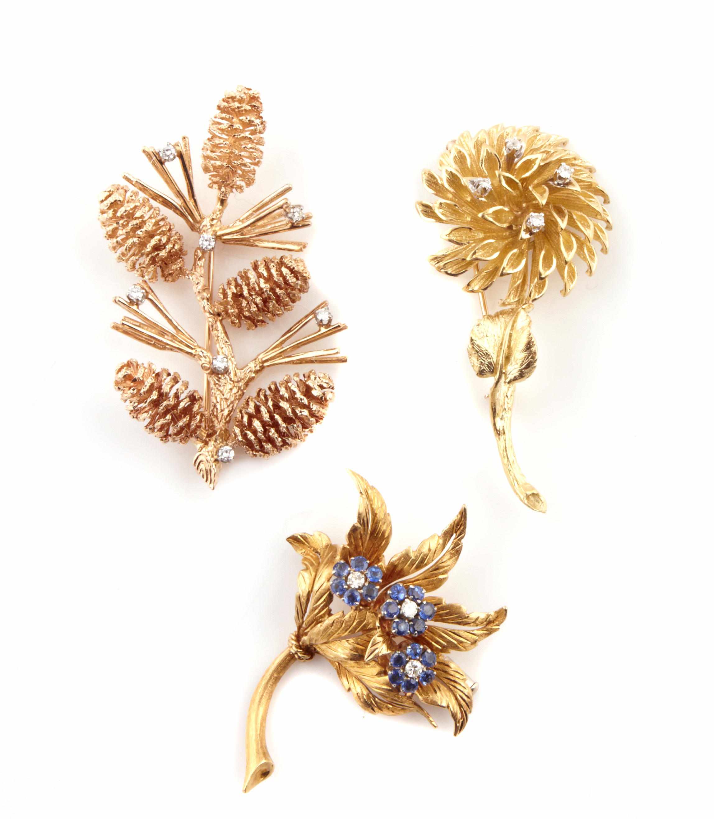 Appraisal: A set of three diamond sapphire and gold brooches comprising