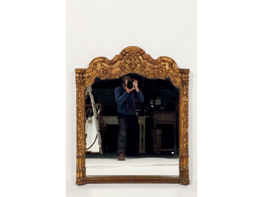 Appraisal: A CONTINENTAL STYLE GILT FRAMED WALL MIRROR the shaped plate