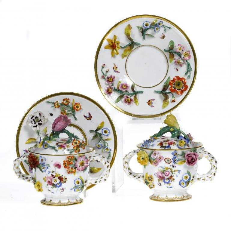 Appraisal: A PAIR OF CHAMBERLAIN WORCESTER FLORAL ENCRUSTED TWO HANDLED CUPS