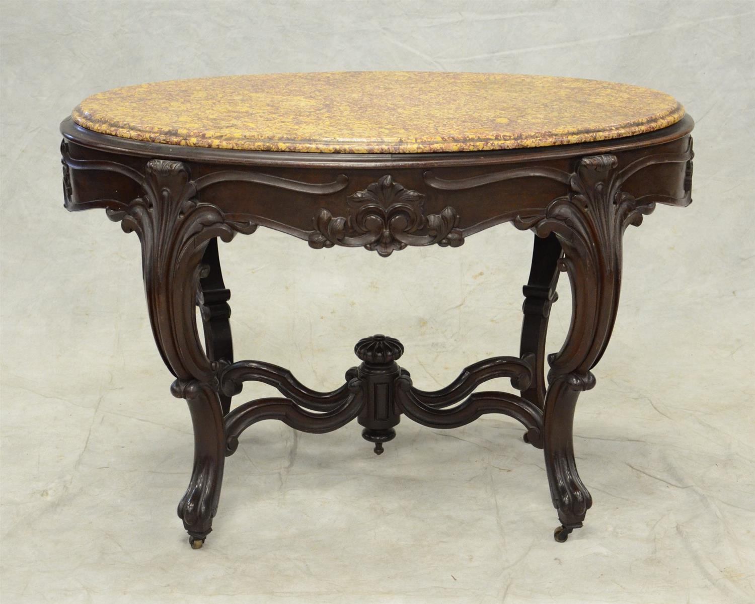 Appraisal: Oval Victorian carved walnut center table with brown fossilized marble