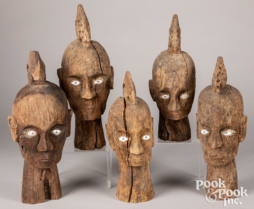 Appraisal: Five Timor carved wooden ancestral heads Five Timor carved wooden