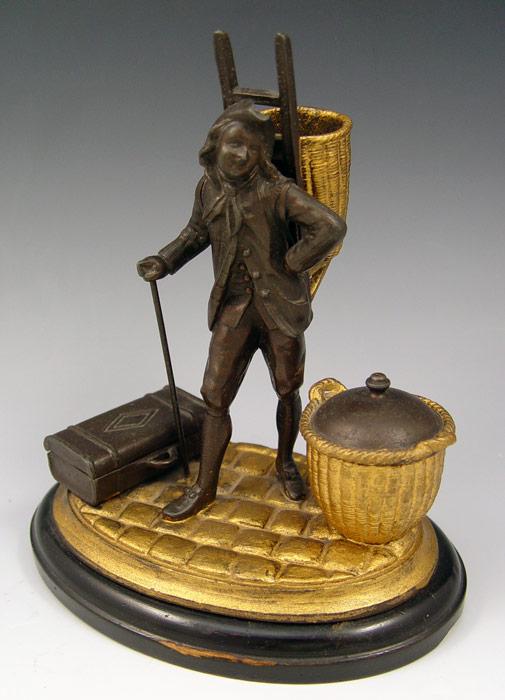 Appraisal: FIGURAL INK STAND Colonist with basket on his back basket