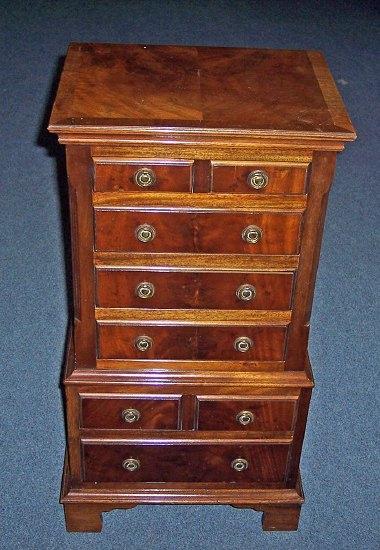 Appraisal: A mahogany miniature chest of four long and four short