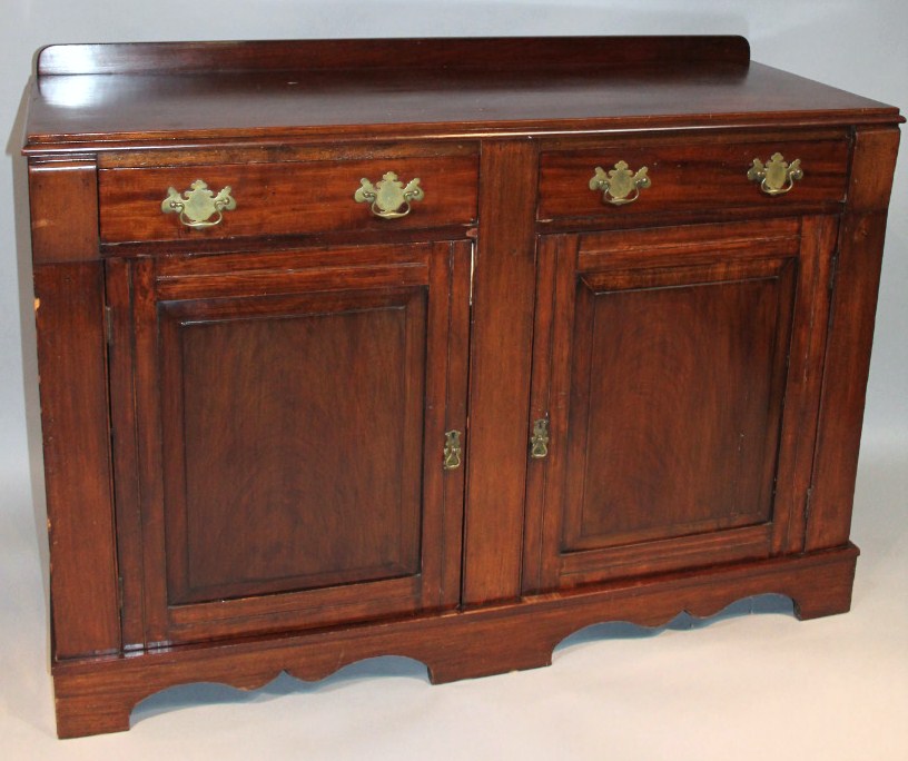 Appraisal: An early thC mahogany stained sideboard the two frieze drawers