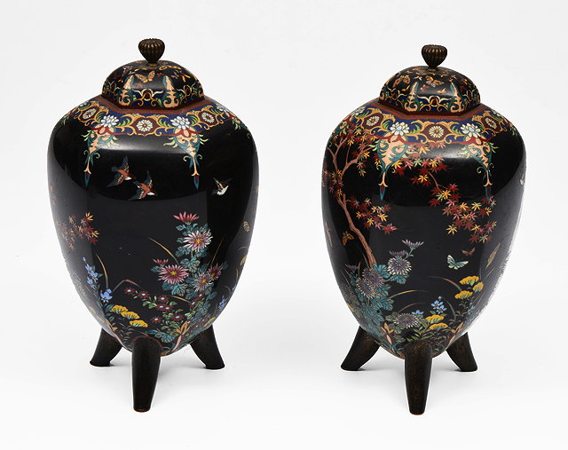 Appraisal: A PAIR OF JAPANESE BLACK GROUND CLOISONNE VASES and covers