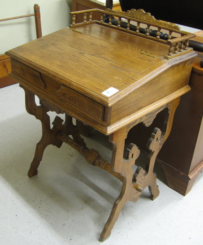 Appraisal: VICTORIAN STYLE OAK LIFT-TOP WRITING DESK American th century Dimensions