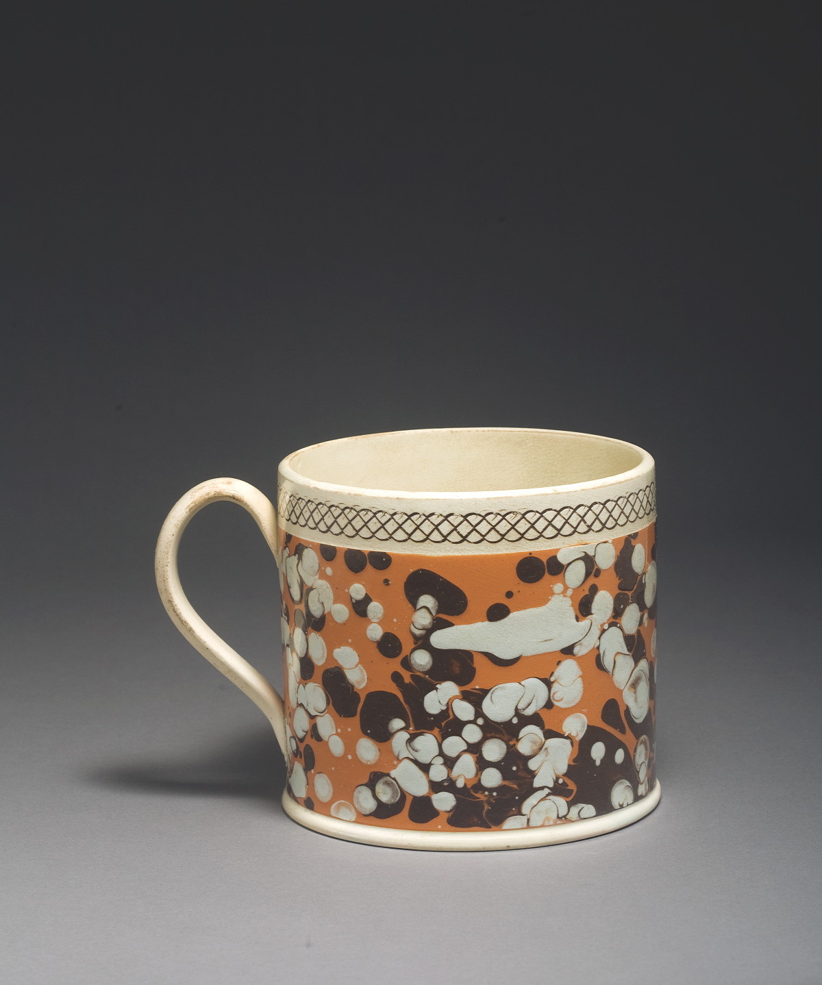 Appraisal: BRITISH PEARLWARE MOCHAWARE MUG CIRCA Slip-marbled in dark brown and