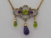 Appraisal: An Edwardian 'Suffragette' style peridot amethyst and diamond pendant the