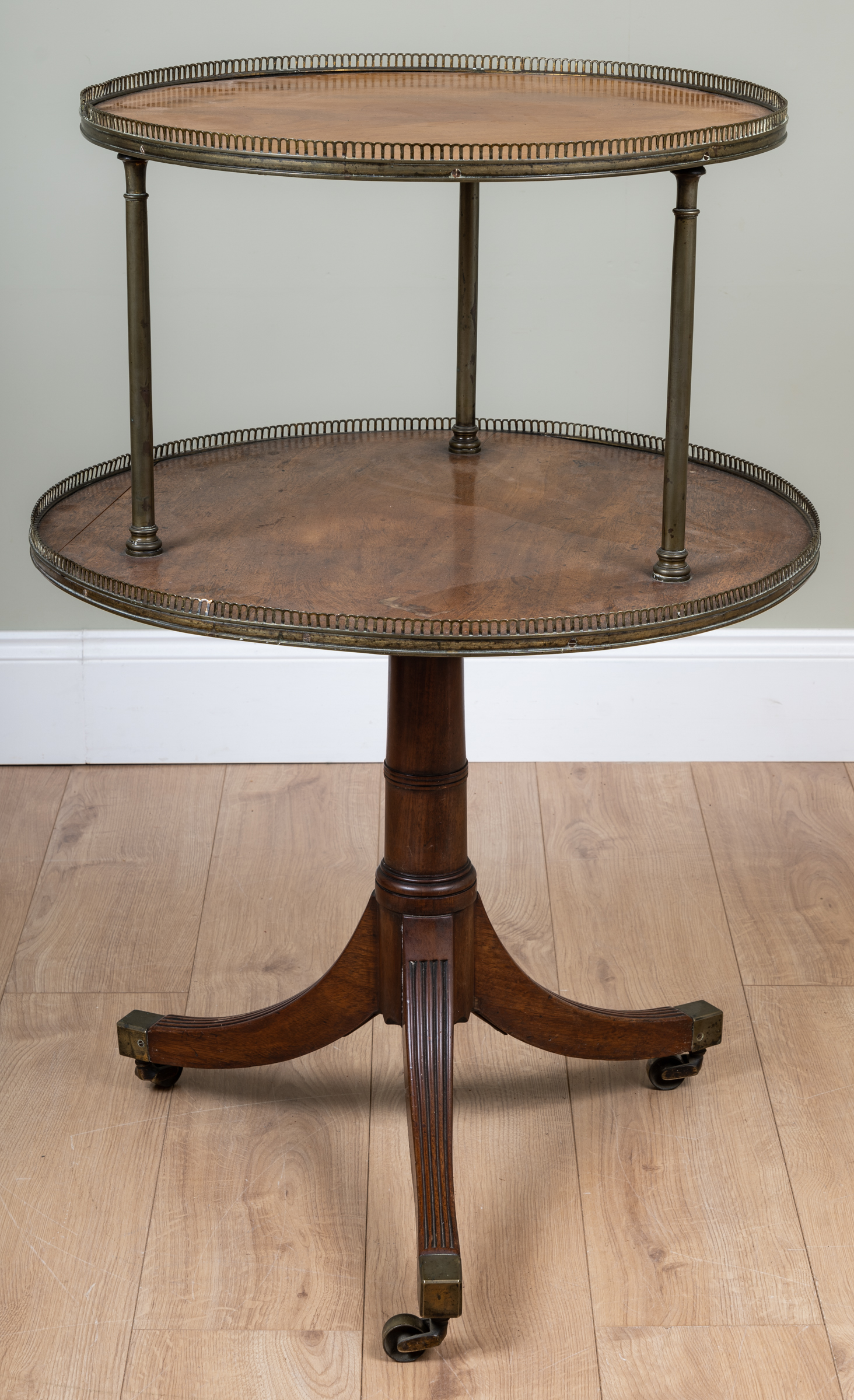 Appraisal: A th century mahogany two-tier circular whatnot with brass column