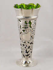 Appraisal: A pierced and embossed silver trumpet vase with green glass