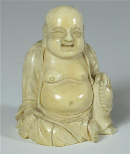 Appraisal: A th century ivory figure of a seated Buddha cm