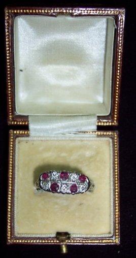 Appraisal: A diamond and ruby two-row ring claw set with alternating