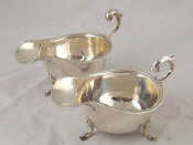 Appraisal: A pair of silver sauce boats with scroll handles on