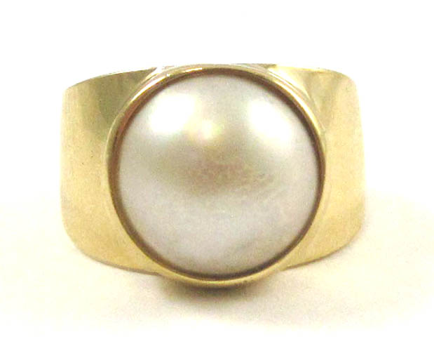 Appraisal: MABE PEARL AND FOURTEEN KARAT GOLD RING The wide yellow