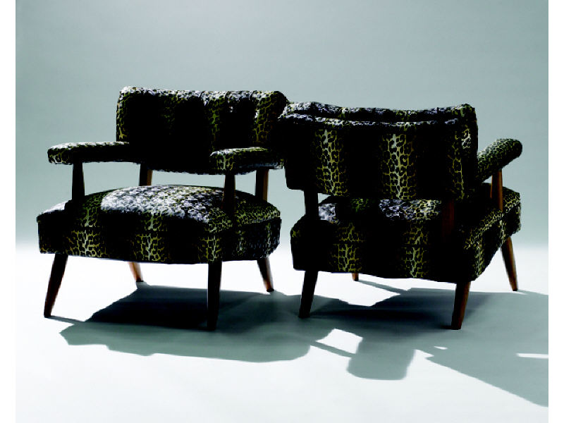 Appraisal: PAIR FAUX LEOPARD LOUNGE CHAIRS Button-back with upholstered seats and