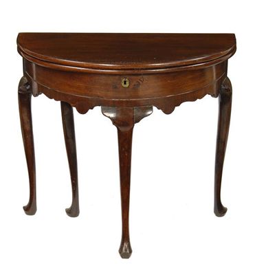 Appraisal: A mahogany demi-lune tea table the fold over top to