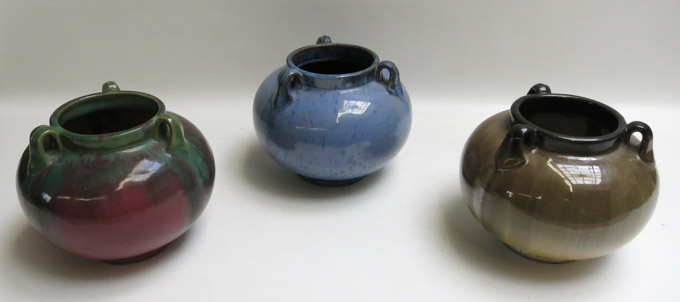 Appraisal: THREE FULPER TRI-HANDLED URNS in blue brown and burgundy glazes