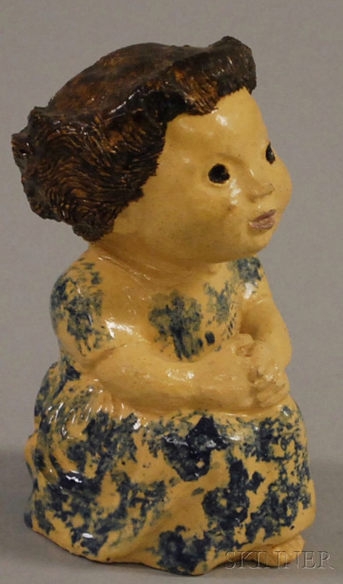 Appraisal: Cobalt Blue Sponge-decorated Pottery Figure of a Girl ht in