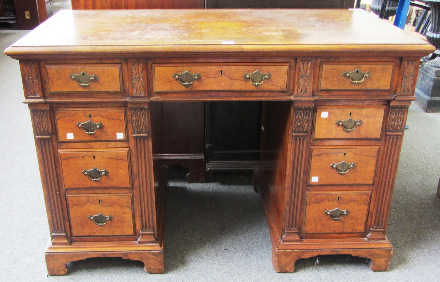 Appraisal: A Victorian walnut pedestal desk with nine drawers about the