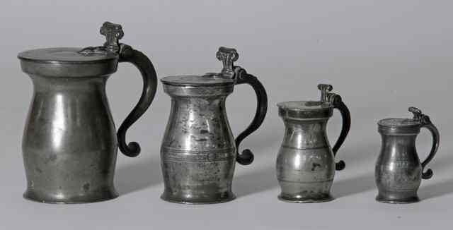 Appraisal: A matched set of four English pewter baluster lidded measures