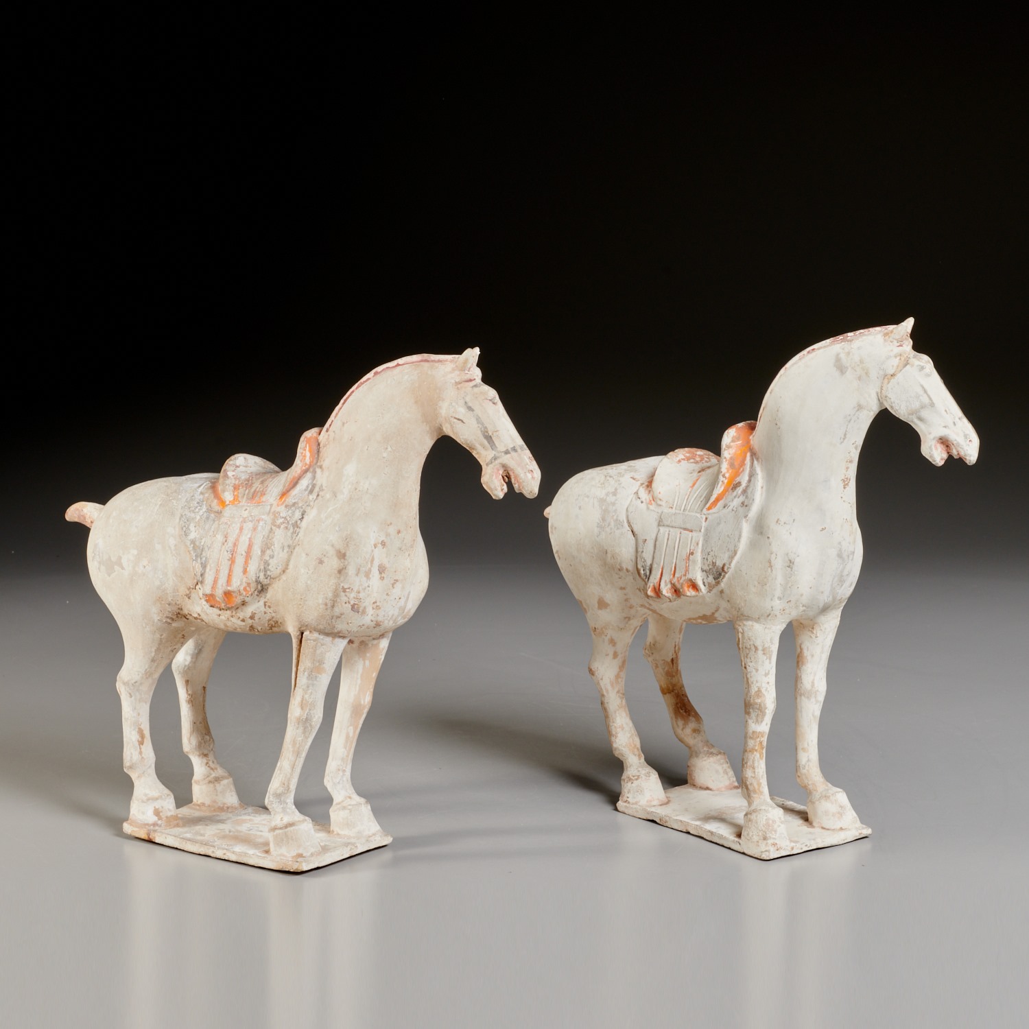 Appraisal: PAIR CHINESE PAINTED POTTERY HORSES Tang Dynasty - CE unglazed