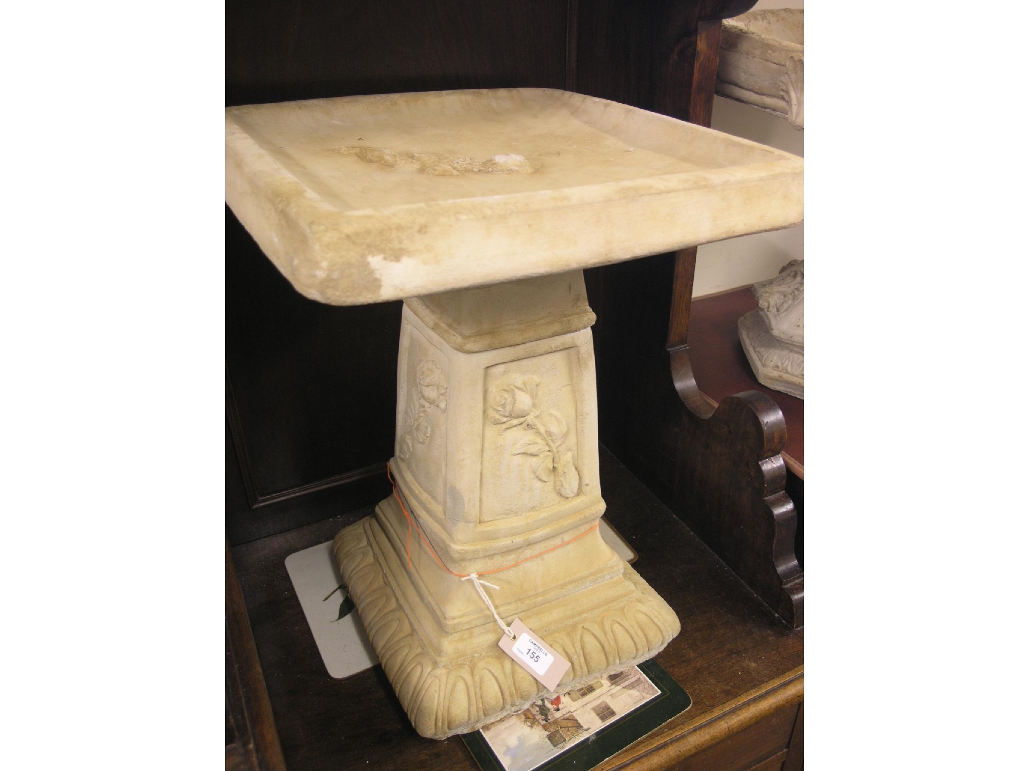 Appraisal: A moulded concrete bird bath square-shape with moulded leaf