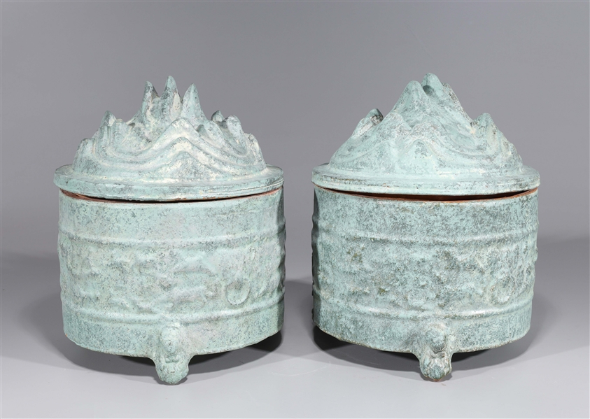 Appraisal: Pair of Chinese ceramic tripod censers with peak form covers