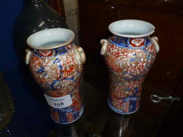 Appraisal: A PAIR OF SMALL ORIENTAL PORCELAIN BALUSTER VASES with ring