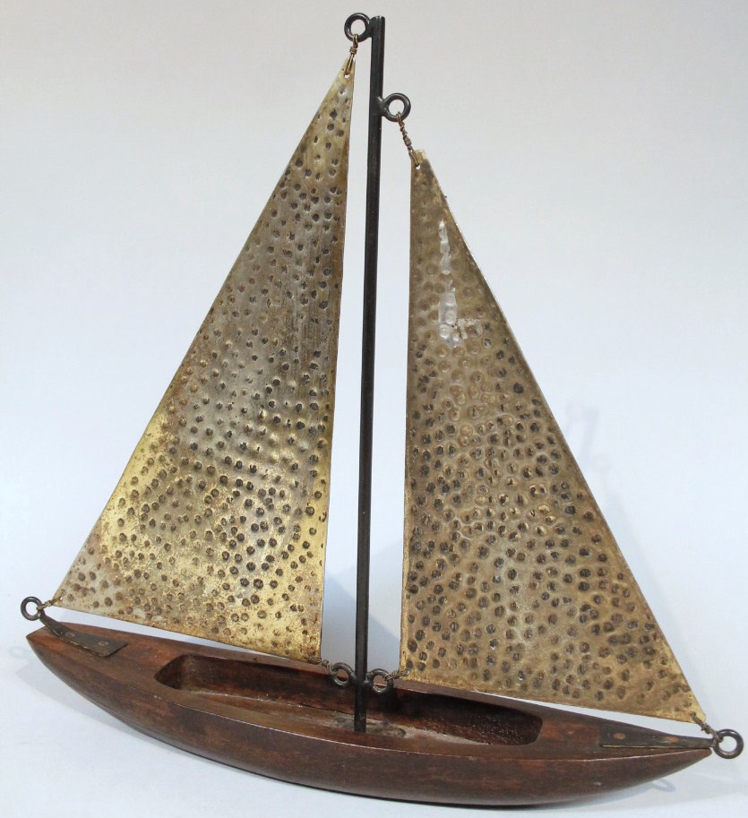 Appraisal: A carved wooden and brass figure of a yacht with