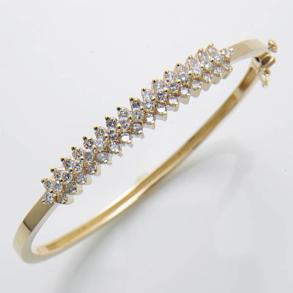 Appraisal: A diamond and k gold bangle bracelet estimated total diamond