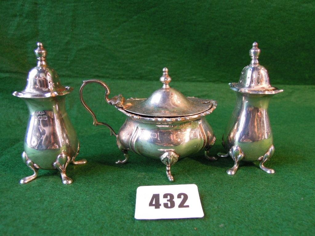 Appraisal: A pair of silver Georgian style pepper pots and a