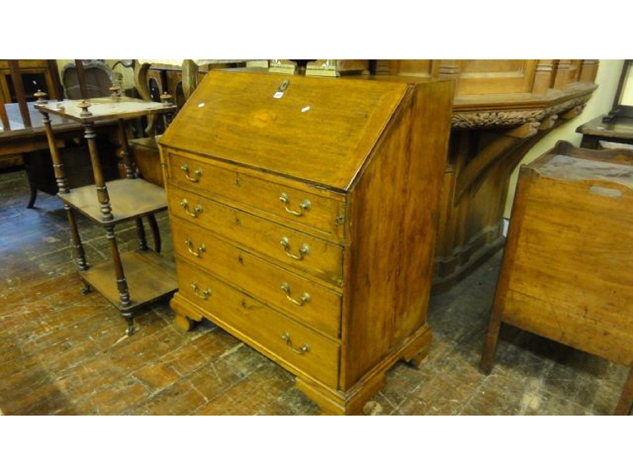 Appraisal: A Georgian oak bureau of four long graduated drawers the