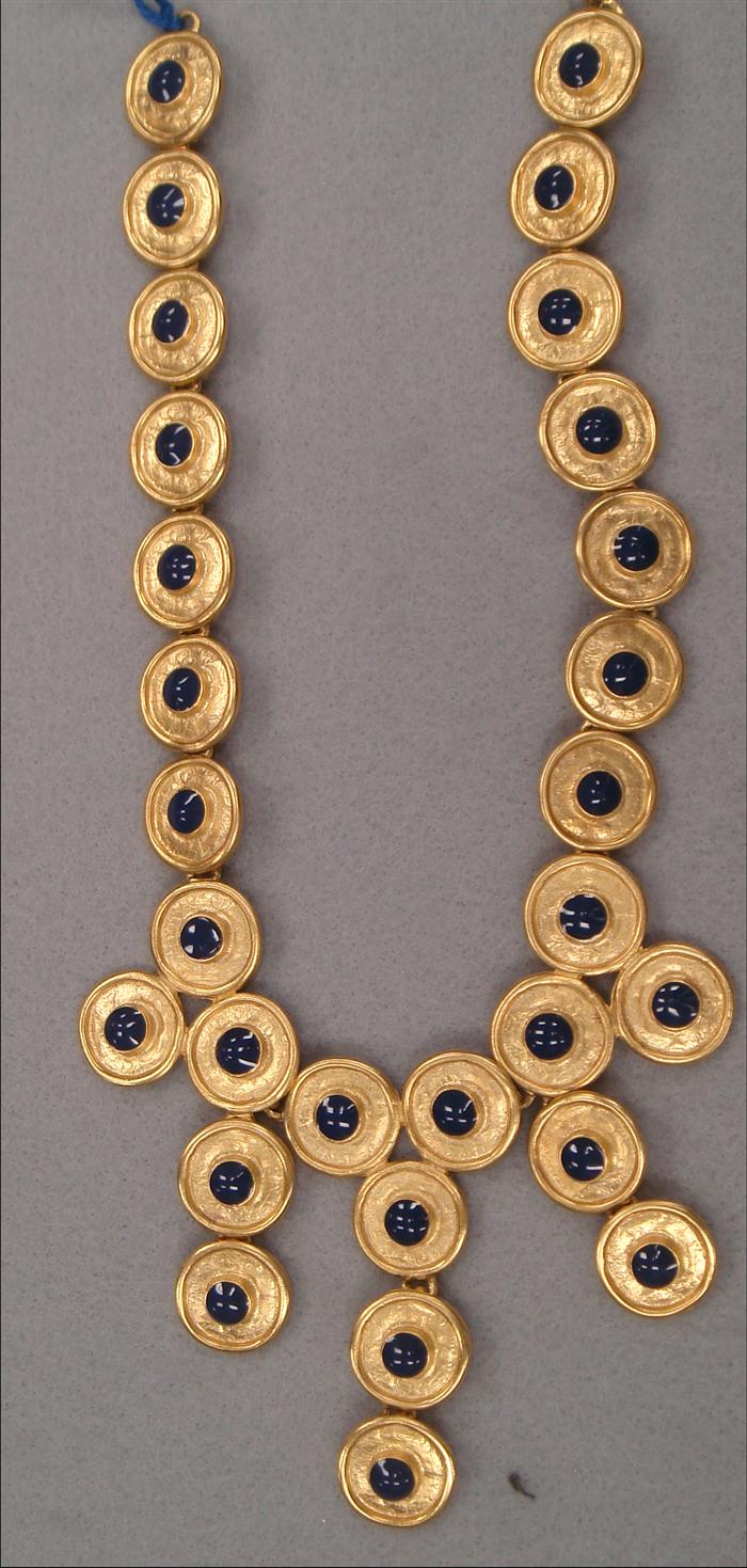 Appraisal: Bib featuring goldtone discs with blue enamel centers Estimate -