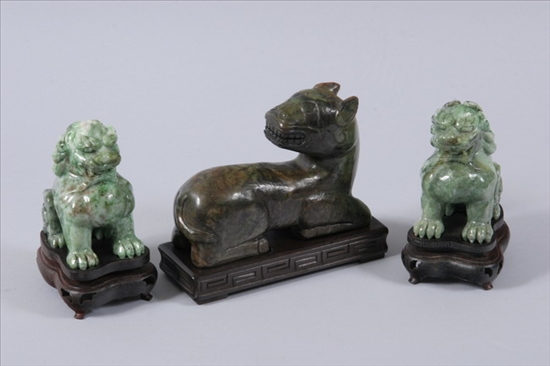 Appraisal: THREE CHINESE GREEN JADE CARVINGS Pair of seated fu dogs