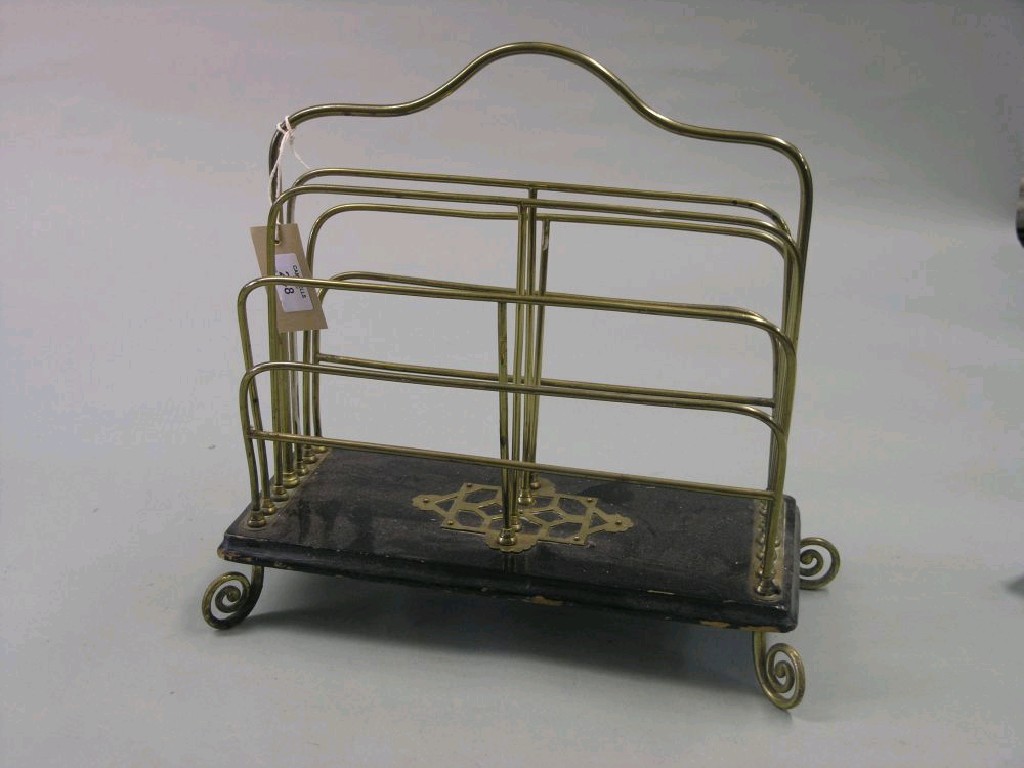 Appraisal: A Victorian brass magazine rack on ebonised base in