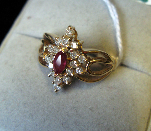 Appraisal: RUBY DIAMOND AND FOURTEEN KARAT GOLD RING centering a marquise-cut