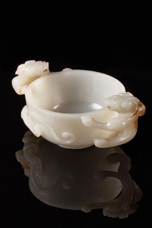 Appraisal: A CHINESE WHITE JADE BOWL the handles formed as two