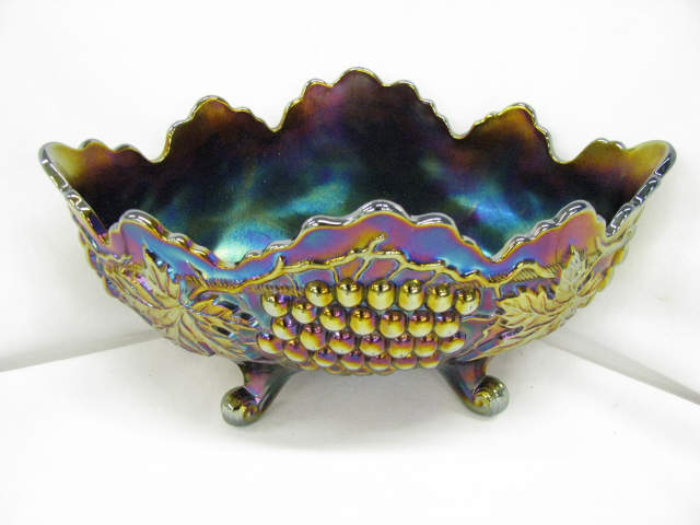 Appraisal: Carnival Glass Grape Cable Banana Bowl amethyst x footed excellent