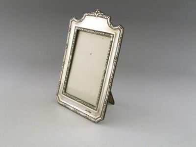 Appraisal: An Edwardian silver photograph frame of arched upright rectangular form