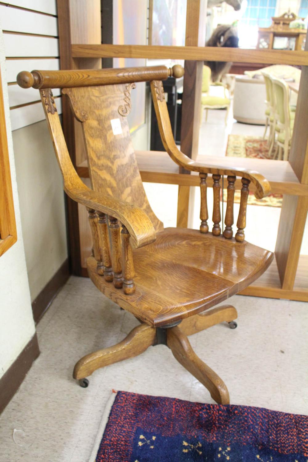 Appraisal: OAK DESK ARMCHAIR American c on swivel base with casters