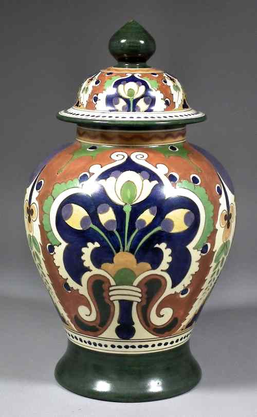 Appraisal: A Gouda pottery baluster shaped vase and cover enamelled in