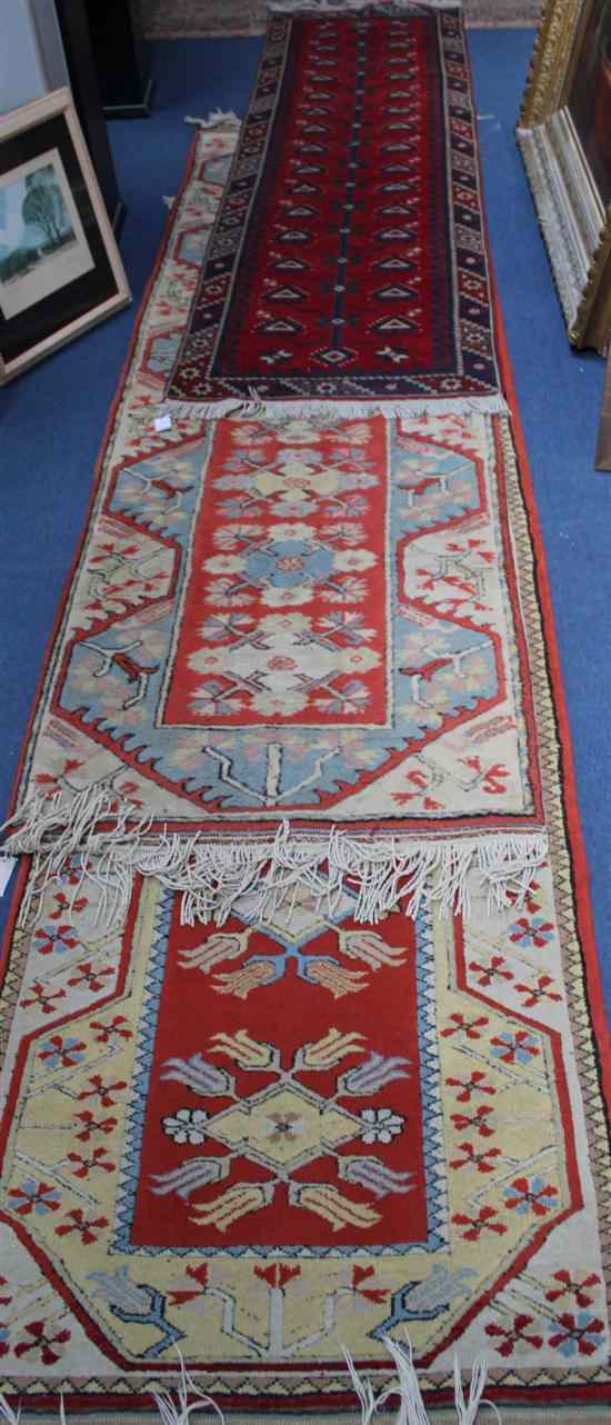 Appraisal: Two similar Turkish runners with floral motifs on a coral