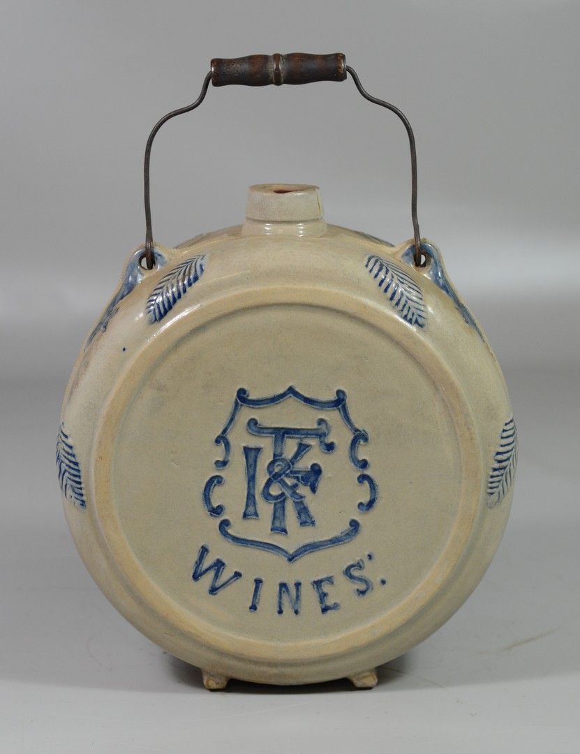 Appraisal: IKF Wines stoneware canteen wire handle blue decorated relief leaf