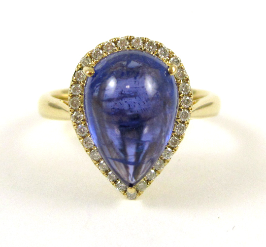 Appraisal: TANZANITE AND FOURTEEN KARAT GOLD RING with round-cut diamonds forming