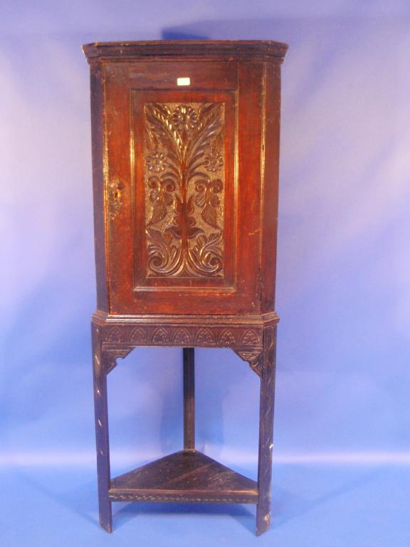 Appraisal: An thC carved oak corner cupboard on stand