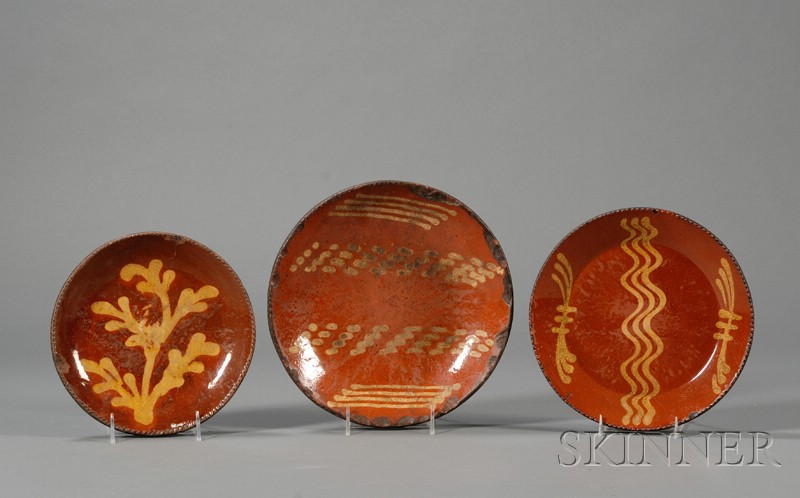 Appraisal: Three Redware Slip-decorated Plates America early th century round plates