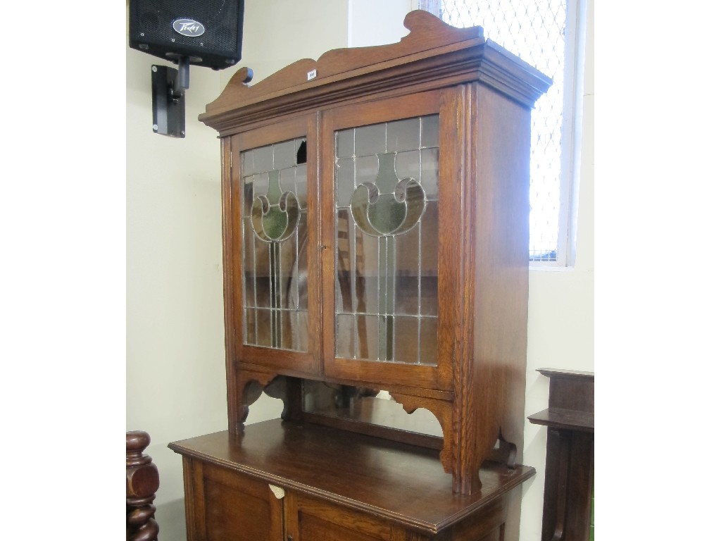 Appraisal: An Art Nouveau bookcase on cupboard chest with two stained