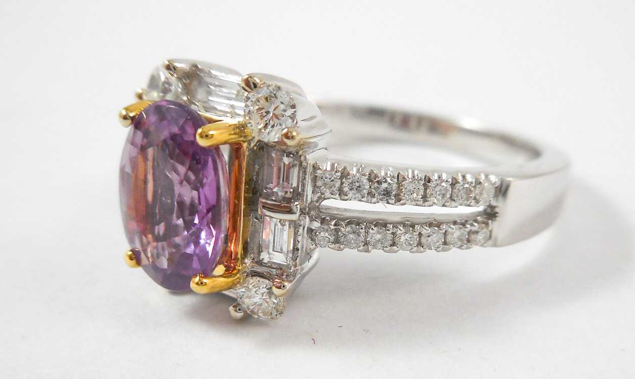 Appraisal: PINK SAPPHIRE AND FOURTEEN KARAT GOLD RING The white and