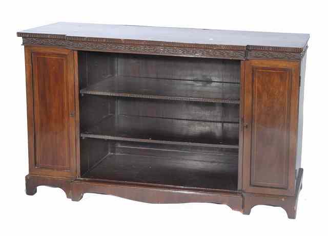 Appraisal: A MAHOGANY BREAK FRONT BOOKCASE the central open shelves flanked